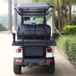 Rear image of the 4+2, passenger, electric, white Fusion electric cart parked outside of a building.